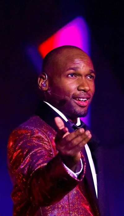 Ishmon Brown performing in a red jacket