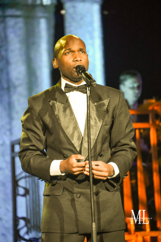 Ishmon Brown singing in a tuxedo