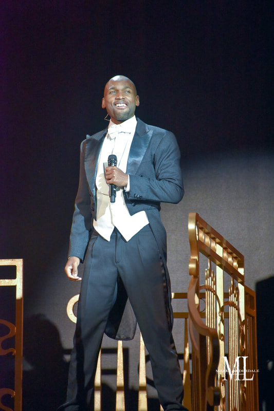 Ishmon Brown holding a microphone on stage