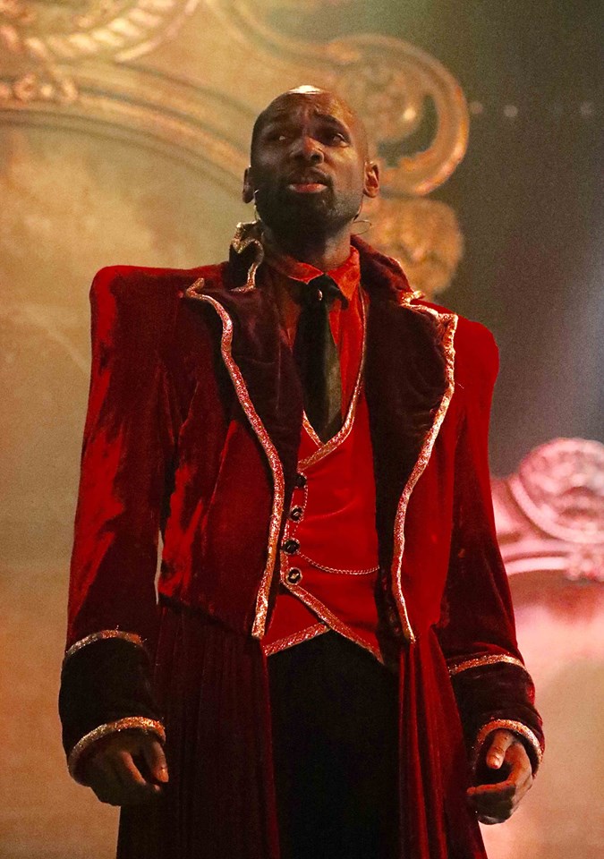 Ishmon Brown performing in a red coat